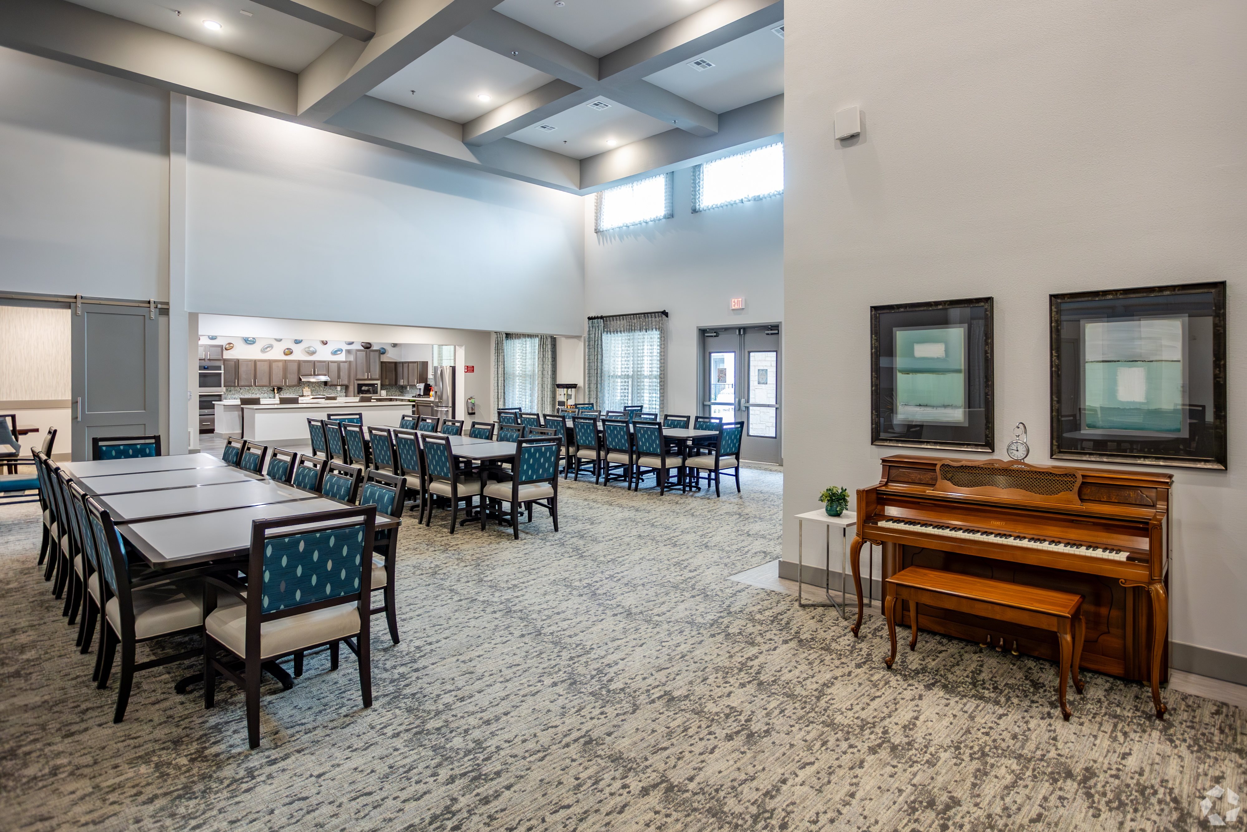A room with a piano and chairs.